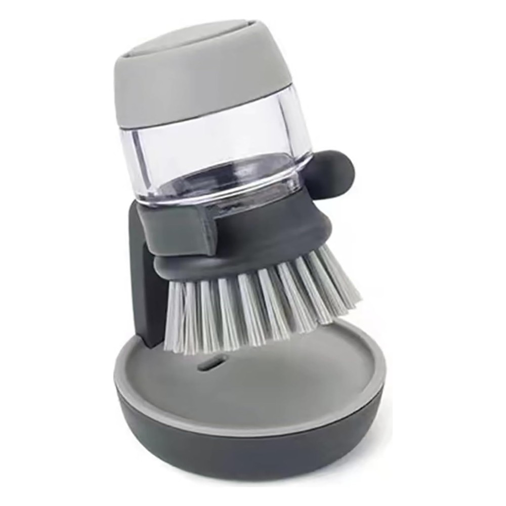 Grey soap dispensing dish brush with a clear refillable body standing in its holder with a drip tray